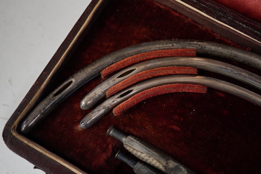 A late 19th century leather cased medical set of catheter surgical instruments, together with a single leather case catheter, plus an early 20th century canvas roll containing a graduated set of gynaecological surgical i